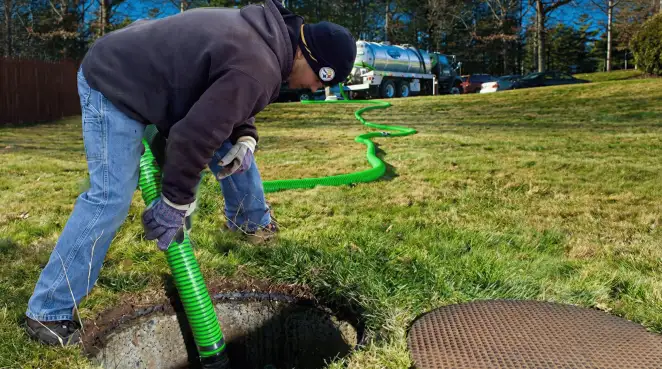 Service technician performing residential septic pumping and drainage maintenance in Salt Lake City, UT